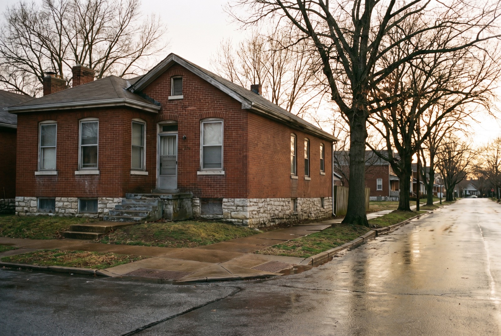 A red brick house on a limestone foundation on a St. Louis street